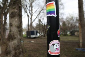  Stickers adorn Joey’s basketball hoop in his driveway, including a pride flag sticker in the shape of South Dakota and an opossum *internal screaming* meme sticker. South Dakota Searchlight photo by Makenzie Huber