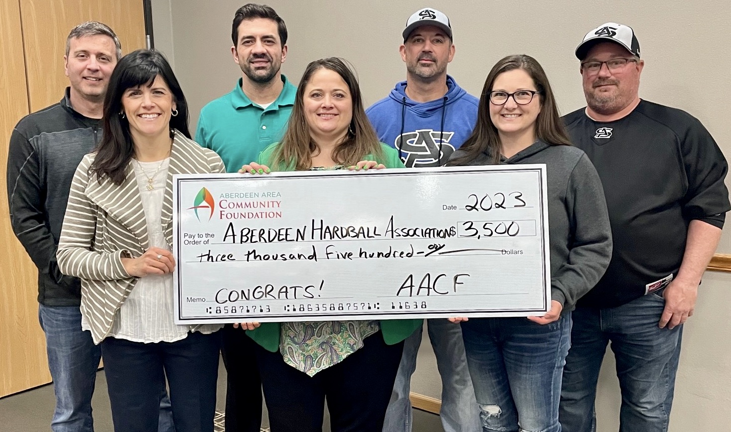 The Aberdeen Area Community Foundation recently provided a grant to the Aberdeen Hardball Association to support its new project to create a traveling team for its youth baseball program. The grant funds will help with equipment purchases and other needs of the program. Pictured for the ceremonial check presentation are, front from left, Aberdeen Area Community Foundation Vice President Megan Biegler, and Aberdeen Hardball Association board members Diane Soderlund and Kelly Ladner; back from left: Aberdeen Hardball Association board members Steve Stickelmyer, Joel Welke, Eric Borge and Troy Woehl. Photo courtesy of Aberdeen Area Community Foundation
