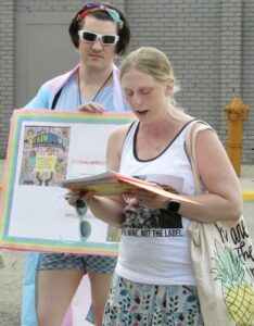 Liza Kollman reads about LGBTQIA+ history on Saturday, June 3 as part of the Aberdeen Area Pride Festival in downtown Aberdeen. Aberdeen Insider photo by Annie Scott