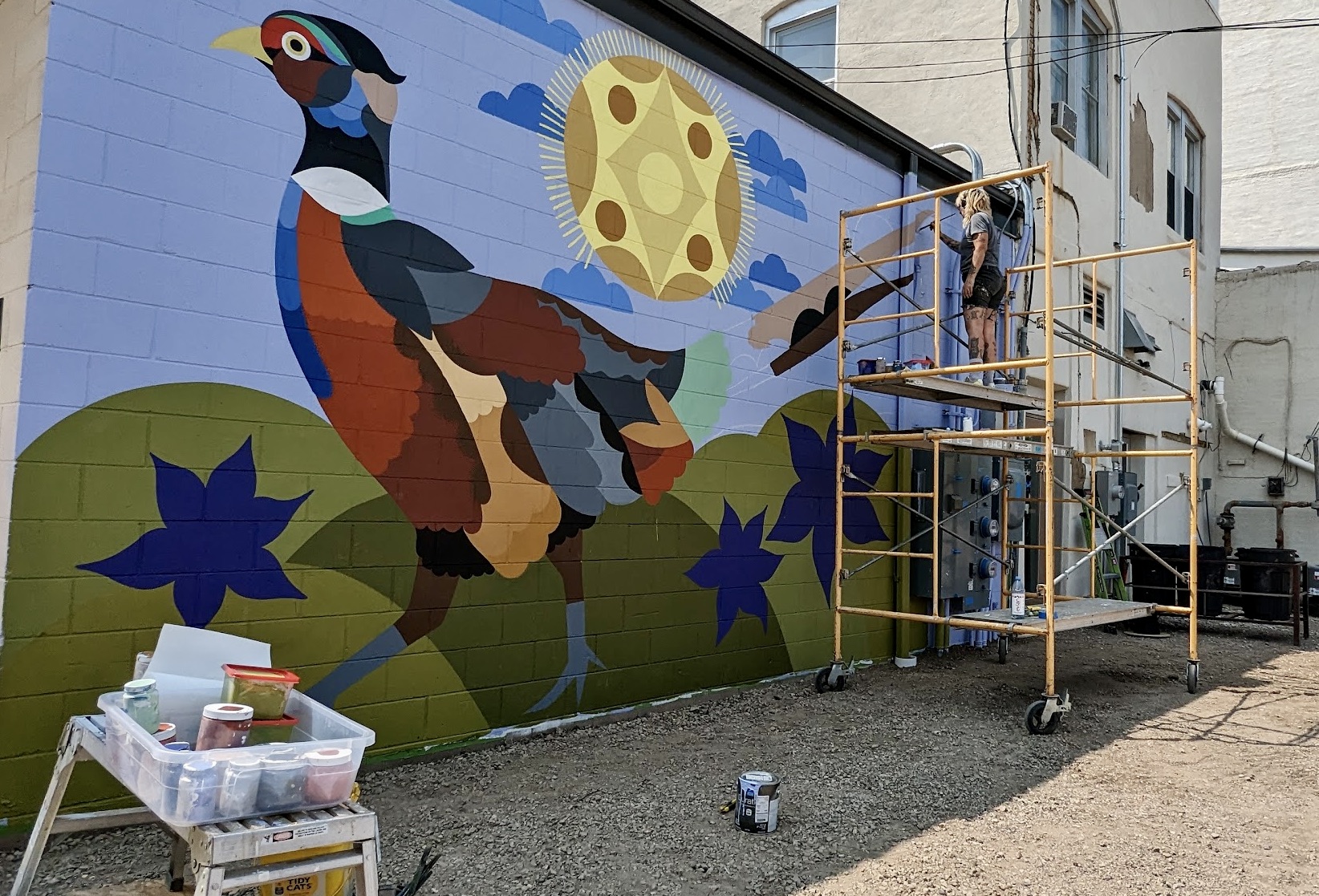 California artist Bunnie Reiss paints a mural on the back of the McQuillen Creative Group/Lily's/ReadiTech building in downtown Aberdeen. Aberdeen Insider photo by Scott Waltman
