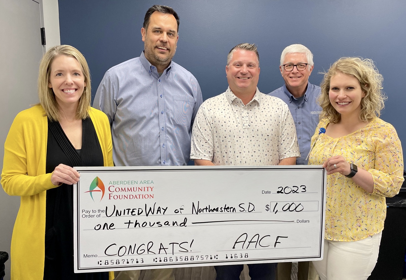 The Aberdeen Area Community Foundation is pleased to support United Way of Northeastern South Dakota with a grant to assist in furnishing its new office space. The Aberdeen Area Community Foundation recently made the ceremonial check presentation at a United Way board meeting. Making the presentation were, from left, Aberdeen Area Community Foundation board member Hannah Walters, United Way Executive Director Aaron Schultz, Aberdeen Area Community Foundation board Chairman Heath Johnson, Aberdeen Area Community Foundation Executive Director Pat Gallagher and Aberdeen Area Community Foundation board member Bea Smith. Photo courtesy of Aberdeen Area Community Foundation