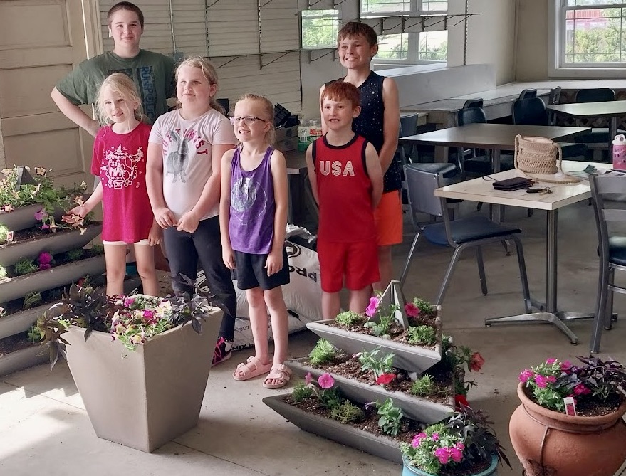 Brown County Cloverbud 4-H'ers learned about horticulture and community service at the Brown County Fairgrounds recently. The kids then helped to beautify the Brown County 4-H and Fair Office by planting some flowers. Pictured from left are Jada Volk, left, Quinn Evans, Maci Volk, Raylinn Robinson, Hunter Hawkinson, Chase Hawkinson. Courtesy photo