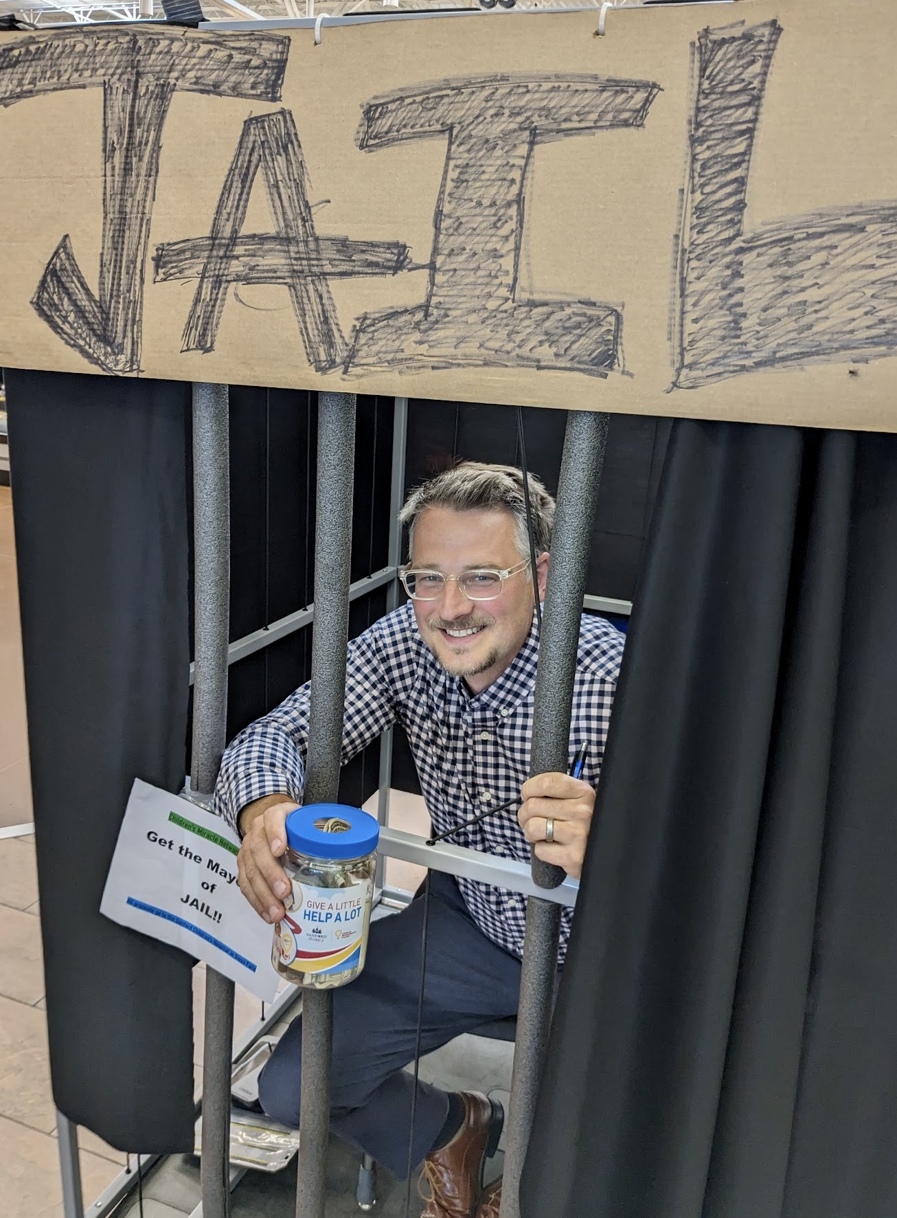 Aberdeen Mayor Travis Schaunaman served time in "jail" Thursday, July 13 attempting to collect $2,000 for the Children's Miracle Network. His "cell" was just inside the main entrance at Walmart. Aberdeen Insider photo by Scott Waltman