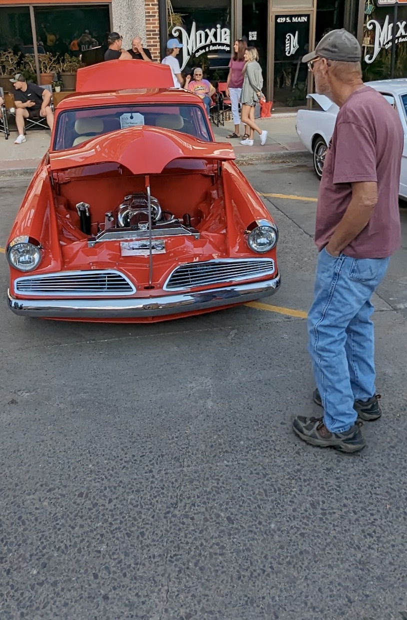 An Sizzlin' Summer Nights car and bike show visitor checks out one of the vehicles the night of Saturday, Aug. 26. Aberdeen Insider photo by Scott Waltman