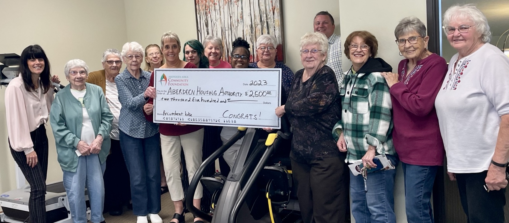 The Aberdeen Housing Authority was awarded $2,500 from the Aberdeen Area Community Foundation for a recumbent cross trainer for Central Villas Apartments. Pictured are Megan Biegler, at left, Aberdeen Area Community Foundation vice chairwoman; and Heath Johnson, in back on the bike, Aberdeen Area Community Foundation chairman; with staff and residents of the Aberdeen Housing Authority’s Central Villas. Courtesy photo