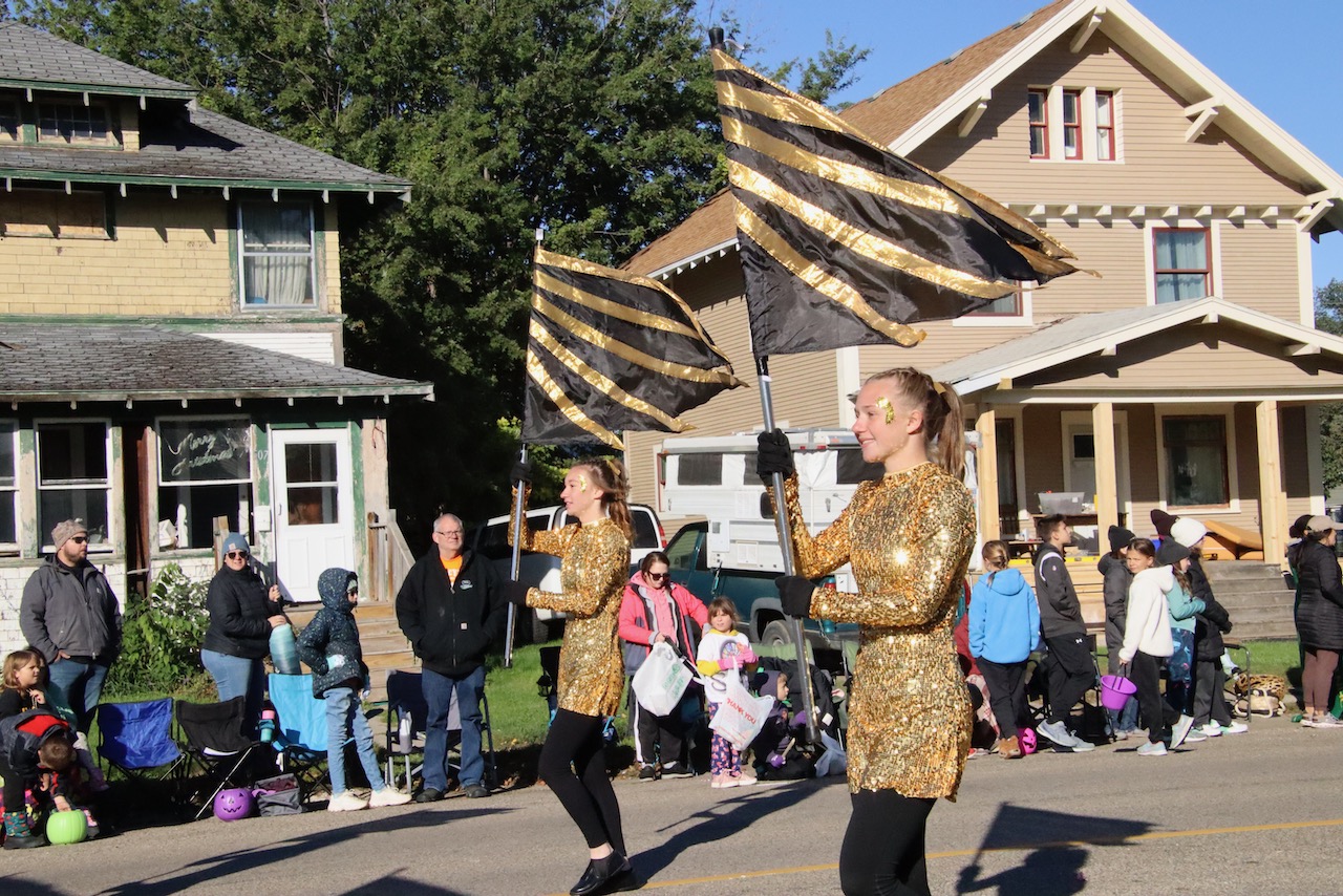 The Groton High School color guard leads the marching band down Main Street in Aberdeen during Northern's homecoming parade on Saturday, Oct. 7. Aberdeen Insider photo by Elisa Sand