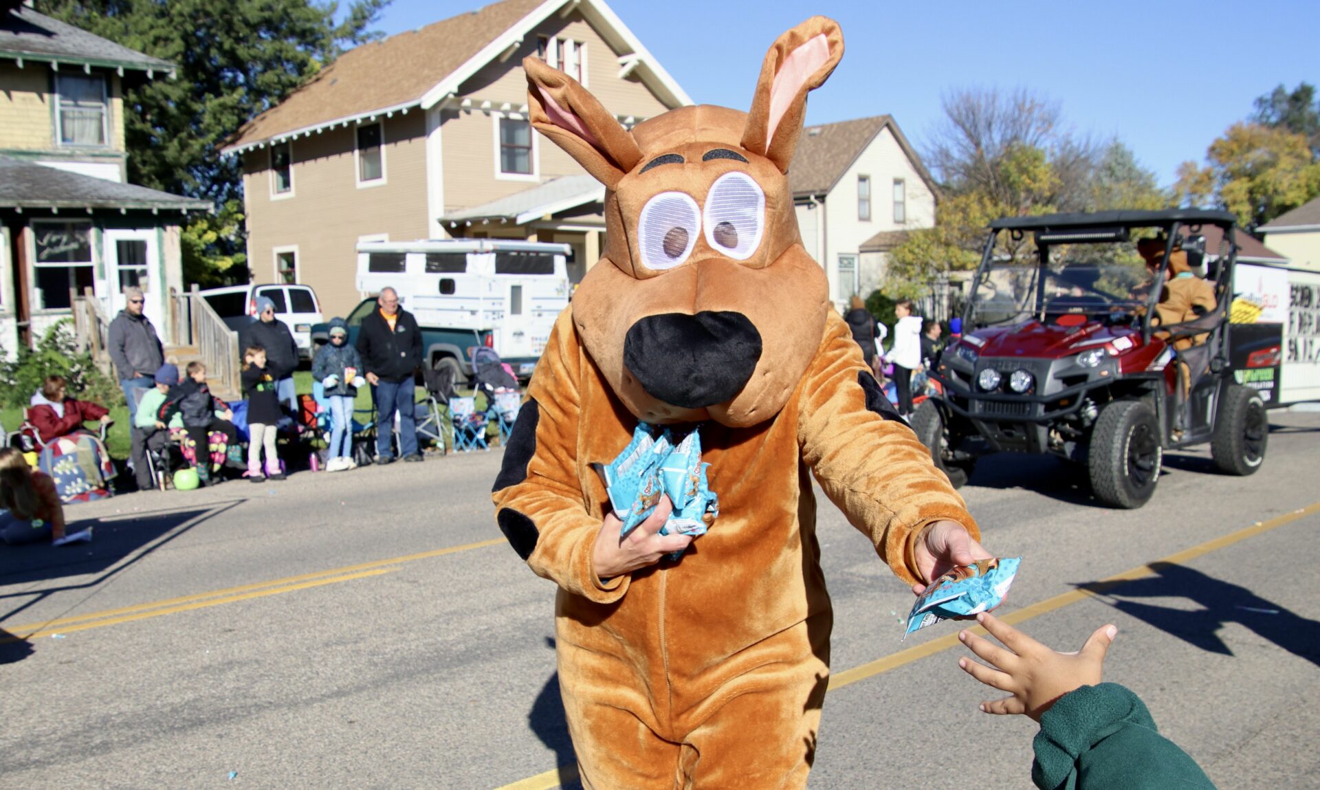Scooby-Doo usually seeks snacks, but he was handing them out during the Northern State homecoming parade on Saturday, Oct. 7. Aberdeen Insider photo by Scott Waltman