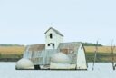 The barn and silos of the Reetz family farm sit in the middle of Reetz Lake. The buildings have become the centerpiece of Sunken Prairie Golf Club, scheduled to open in spring 2028 just south of Webster. Aberdeen Insider photo by Robb Garofalo.