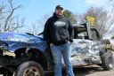 Aberdeen's Derek Cleveland leans against his demolition derby car that helped him and three other drivers win the Cornhusker Chaos four-man derby Saturday, Feb. 7 in Grand Island, Neb. Aberdeen Insider photo by Robb Garofalo.